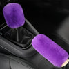 A set of purple plush covers for a car gear shift and handbrake.