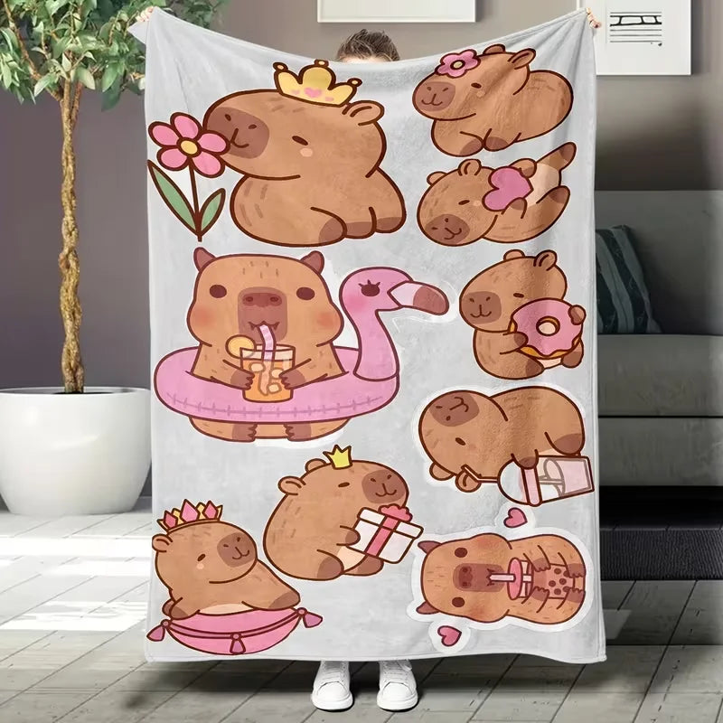 A white flannel throw blanket featuring a cartoon design of several cute brown capybara bears.