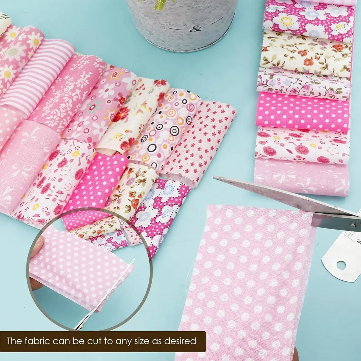 A collection of pink cotton quilted fabric strips in various patterns and colors are laid out on a light blue surface.