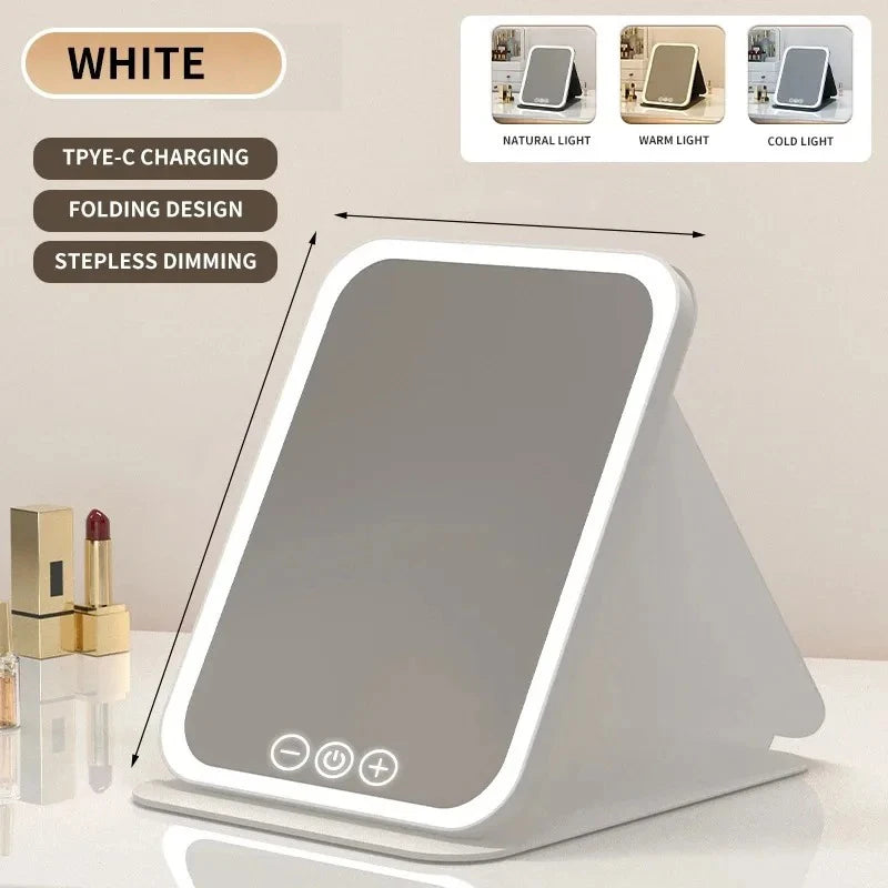 A white portable touch vanity mirror with customizable natural, warm, and cold LED lights is shown on a surface.