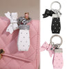 Pink quilted PU leather handbag with a white and silver bow keychain attached.