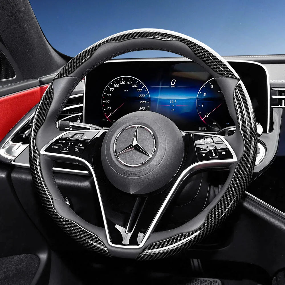 Close-up of a black carbon fiber texture steering wheel cover for a Mercedes-Benz interior.
