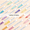 A variety of acrylic paint marker pens in different colors and fine tips arranged diagonally on a light background.