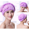 A woman models a purple microfibre quick-dry hair towel wrap with a bowknot on her head.