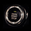 Close-up of a black button cover featuring an ornate crystal rhinestone ring for engine start and stop.