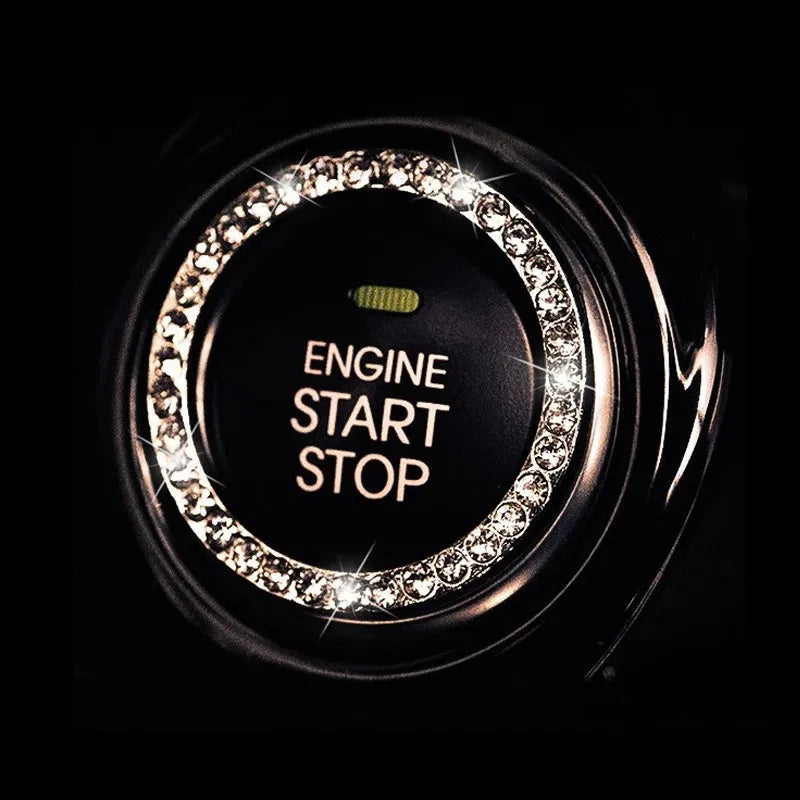 Close-up of a black button cover featuring an ornate crystal rhinestone ring for engine start and stop.