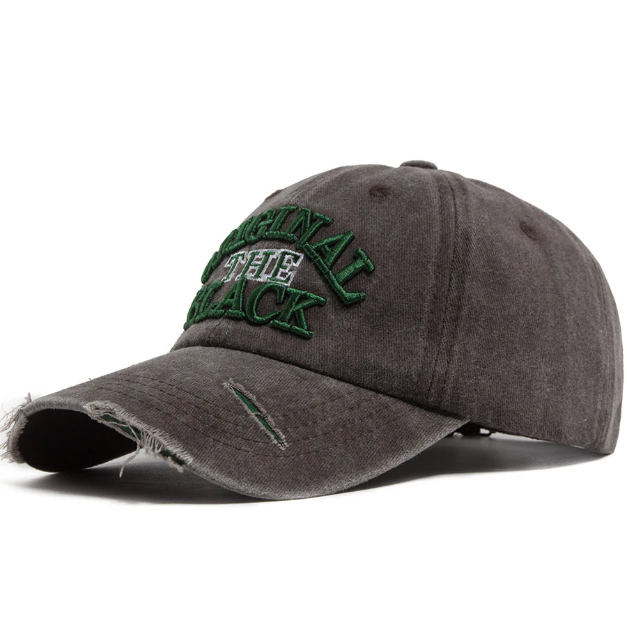 A dark gray vintage washed cotton baseball cap with green embroidered lettering.