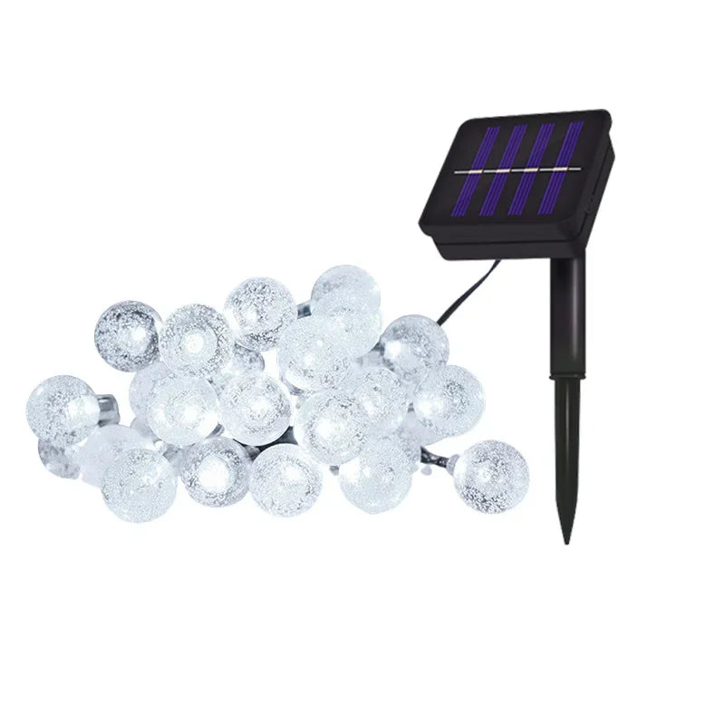 String lights featuring clear crystal globe bulbs powered by a solar panel.