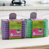 A pack of four green and purple Scrub Boss non-stick kitchen scouring sponges.