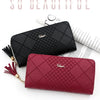 A close-up of a black quilted leather wristlet clutch wallet and a maroon quilted leather clutch wallet.