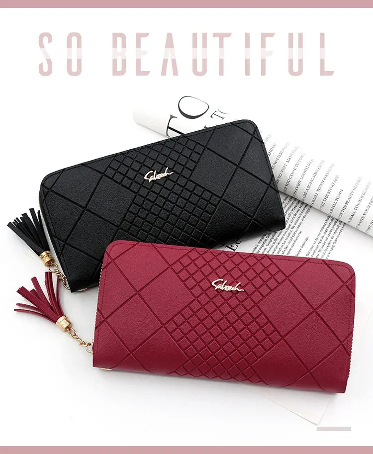 A close-up of a black quilted leather wristlet clutch wallet and a maroon quilted leather clutch wallet.