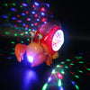 A pink and orange interactive crawling crab toy with bright lights is illuminated against a dark background.