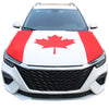 A white car hood covered with a red and white maple leaf design.