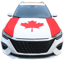 A white car hood covered with a red and white maple leaf design.