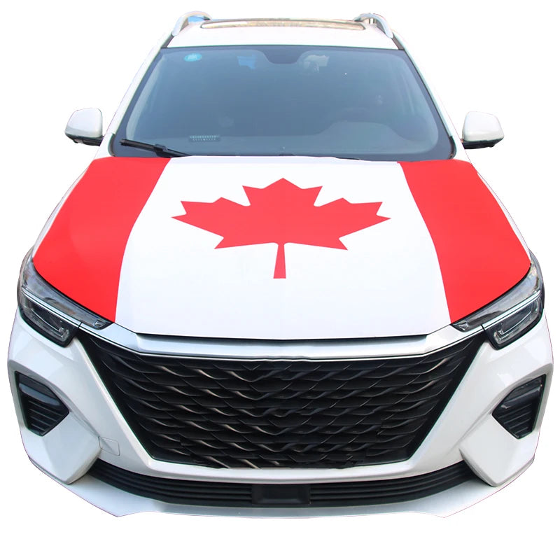 A white car hood covered with a red and white maple leaf design.