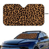 Leopard print car windshield sunshade applied to a blue car.