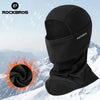 Black Rockbros windproof full face balaclava mask shown against a snowy mountain background