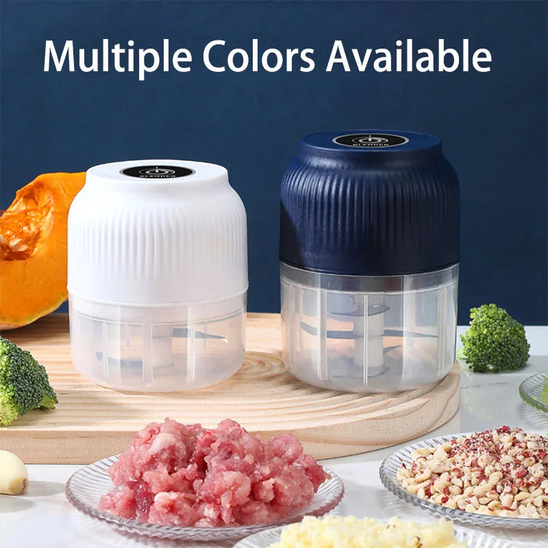 A white and blue mini electric food chopper with various food ingredients displayed on a wooden cutting board.