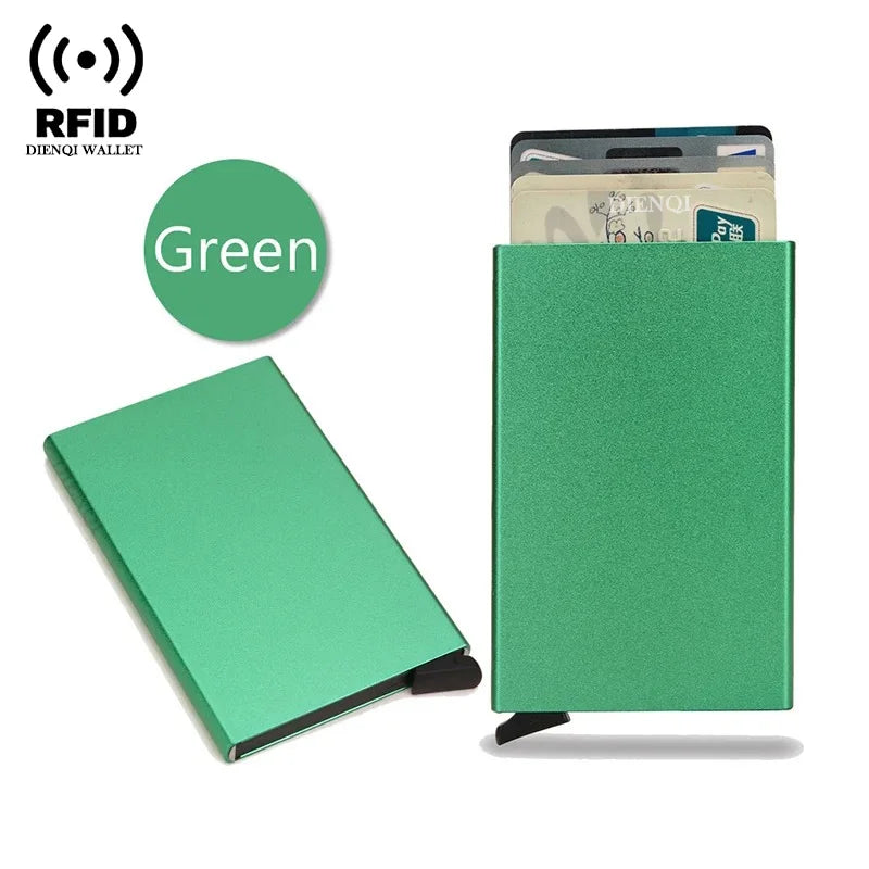 A green slim metal RFID blocking card holder with a pop-up design and a credit card inside.