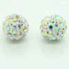 Two spherical beads covered in iridescent glitter and small colored stones for DIY jewelry making