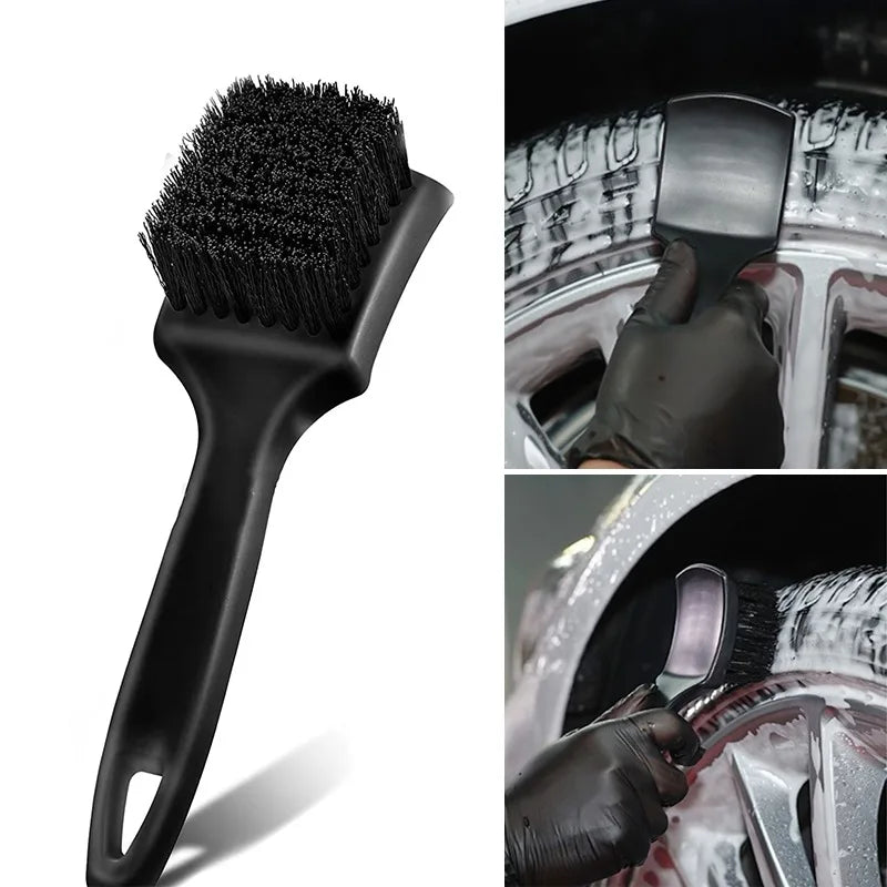 A black heavy-duty tire and wheel cleaning brush set being used to clean a car wheel.