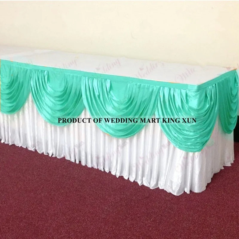 Elegant ice silk table skirt with matching top swag in white and mint green colors.