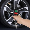 A hand holds a digital tire pressure gauge with an inflation gun connected to a car wheel.