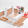 A set of wooden train track expansion packs in various sizes and colors displayed in their original packaging.