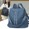 A navy blue women's anti-theft leather backpack with a floral pattern is shown next to a woman.