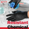A hand wearing a black nitrile disposable glove is pouring blue liquid from a glass into a bottle.