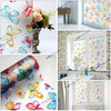 Floral butterfly pattern window film applied to a glass pane in a bright room.