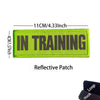 A rectangular lime green reflective patch embroidered with the text IN TRAINING and dimensions listed.