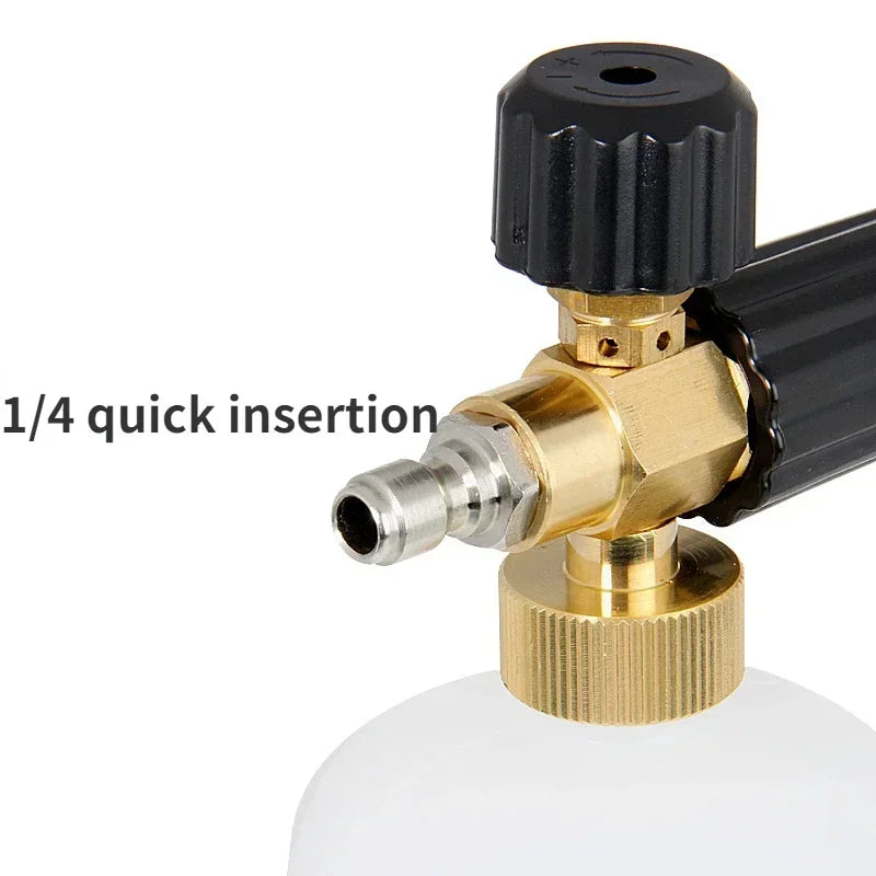 Close-up of a black high-pressure foam lance with a brass fitting and a white bottle base.