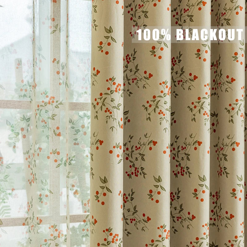 A close-up of a beige blackout curtain panel featuring a red and green plant pattern.