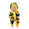 A baby doll wearing a yellow and blue sunflower print jumpsuit outfit.