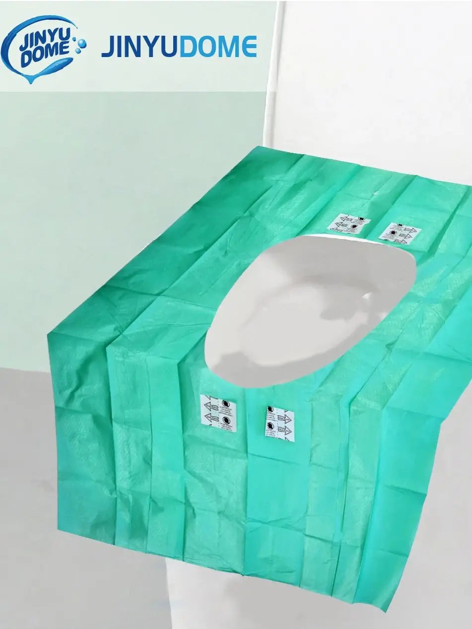 A green disposable toilet seat cover is shown, folded and ready for use.