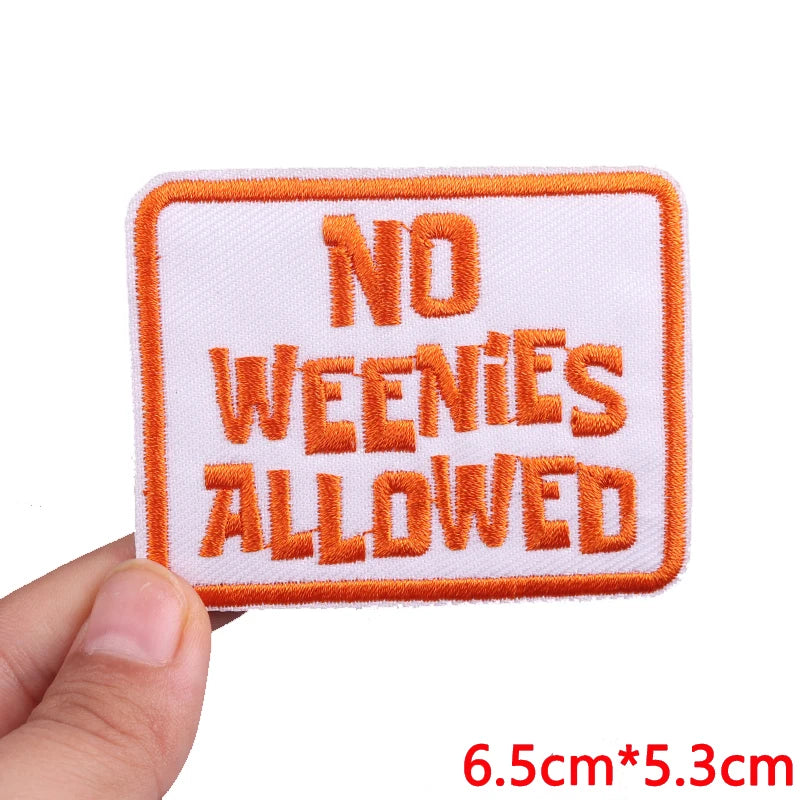 An orange embroidered patch with the text NO WEENIES ALLOWED on a white background.
