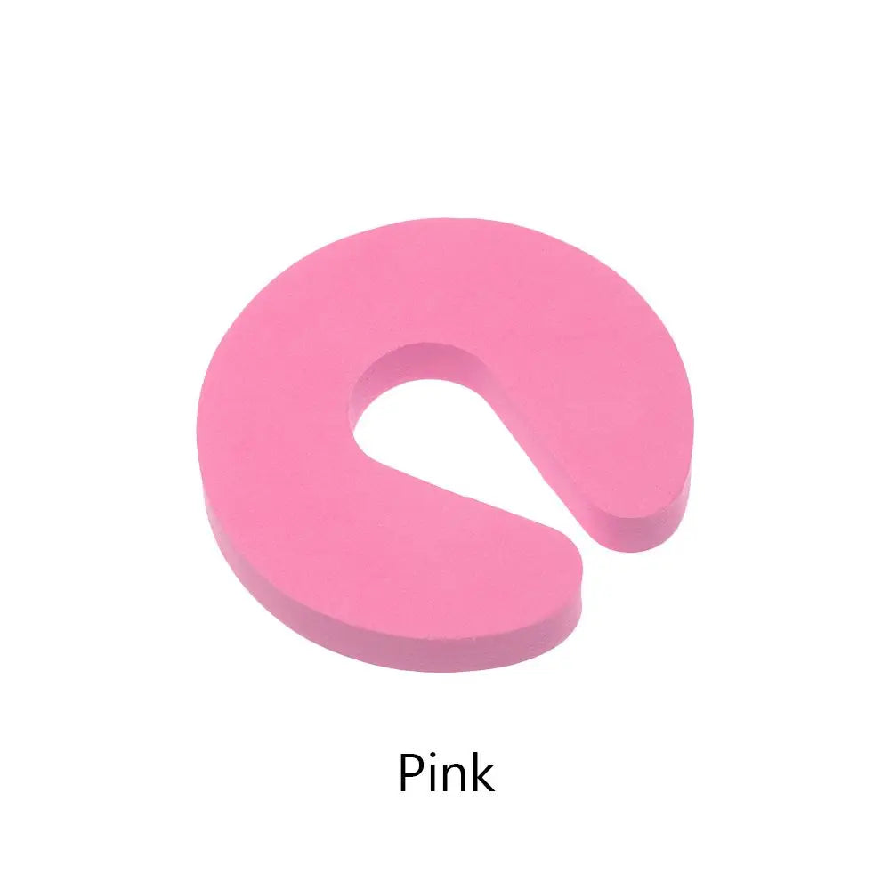 A pink foam door stopper with a finger pinch protection design.