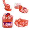 A jar of pink and orange slime with various colorful jelly cubes and glitter inside.