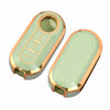 A luxury leather key case with a light green body and gold accents, showing the interior key slots.