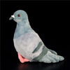 A soft gray plush toy of a pigeon with a pink underside is shown against a black background.
