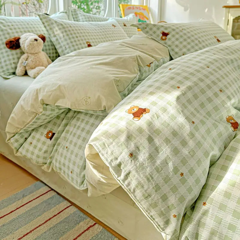 A light green and white checkered duvet cover set with matching pillow shams displayed on a bed.