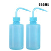 Two clear blue squeeze bottles with long tips for tattoo ink or liquid application