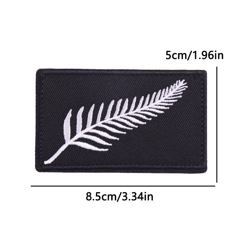 Black embroidered iron-on patch featuring a white feather design.