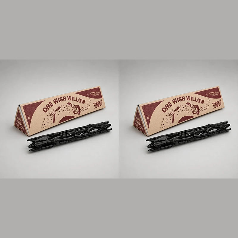 A black willow wood wishing stick with a gift box is shown on a light gray background.