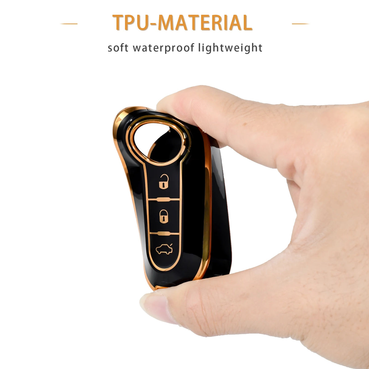 A hand holds a black TPU material key case with gold accents, showing the key slots.