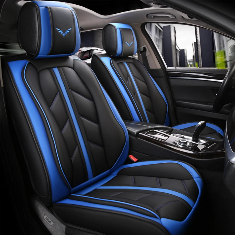 Black car seat covers with blue stitching and accents installed in a vehicle interior.