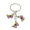 A silver hoop keychain charm featuring a colorful butterfly design in pink and yellow.