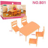 A miniature dollhouse furniture set featuring wooden chairs and a table with forest animal figures.
