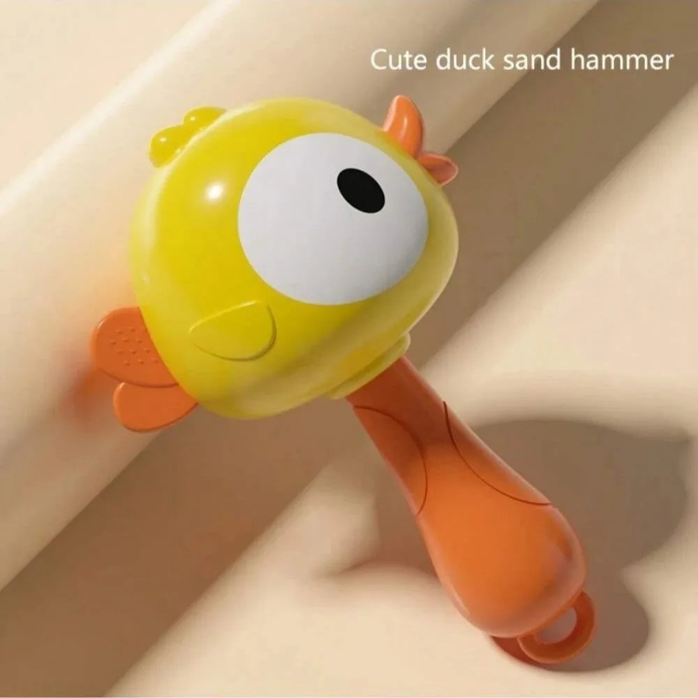 A yellow duck sand hammer toy with large eyes and an orange handle is shown against a light background.